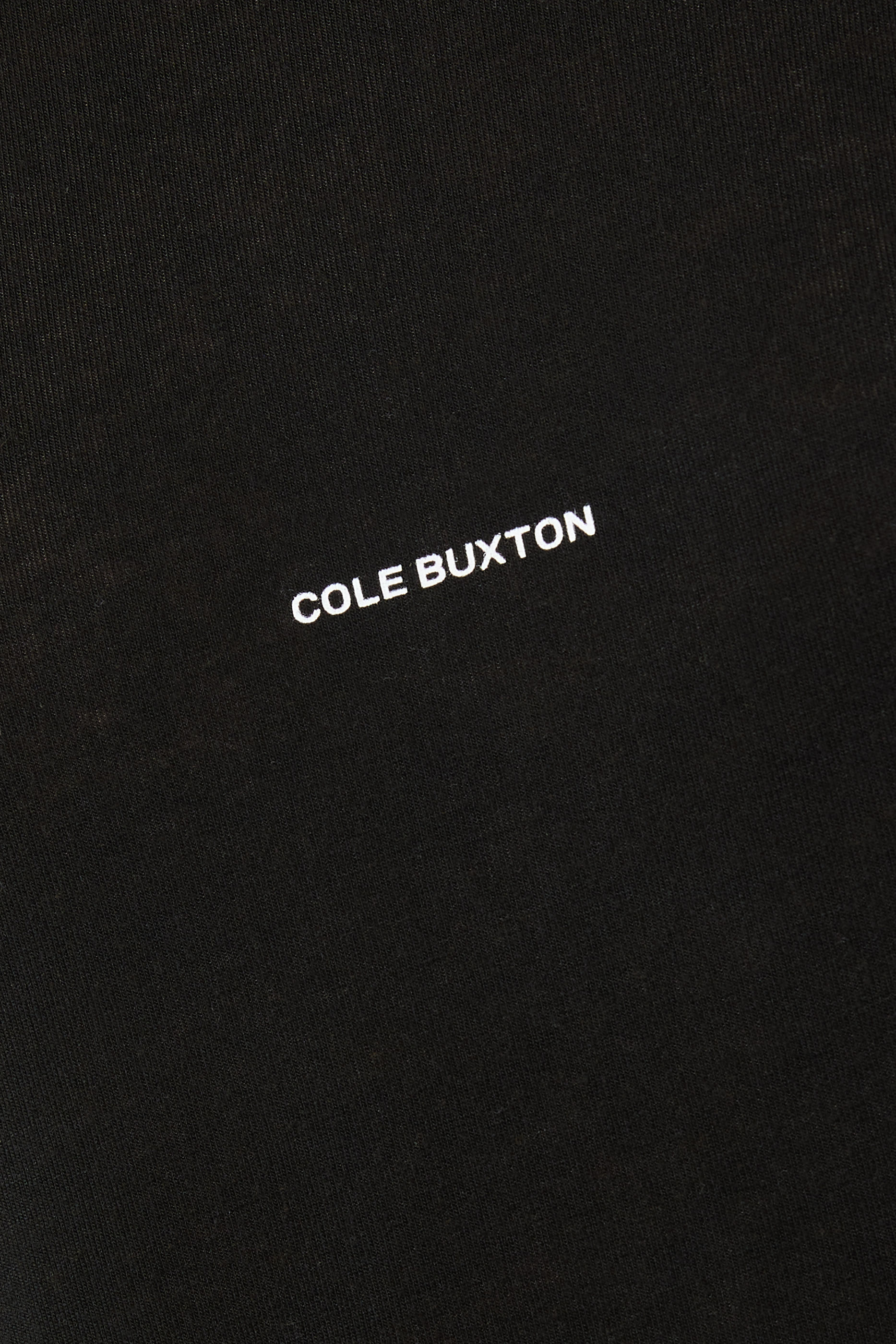 تيشيرت بأكمام طويلة شفاف بشعار الماركة صغير